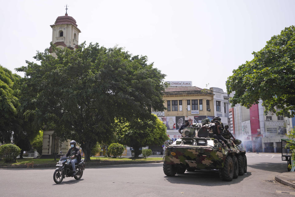 Sri Lankan army soldiers patrol during curfew in Colombo, Sri Lanka, Wednesday, May 11, 2022. Sri Lanka's defense ministry ordered security forces on Tuesday to shoot anyone causing injury to people or property to contain widespread arson and mob violence targeting government supporters.(AP Photo/Eranga Jayawardena)