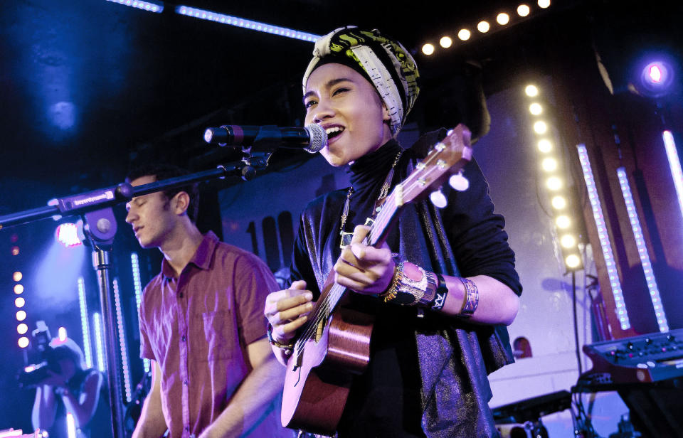 A photo of Malaysian celebrity Yuna, performing on stage.