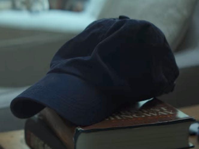 Joe's hat sitting on a book on Netflix's "You."