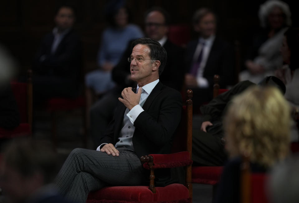 Caretaker Dutch Prime Minister Mark Rutte jokes prior to Dutch King Willem-Alexander's speech which marks the opening of the parliamentary year outlining the government's budget plans for the year ahead at the Grote Kerk, or Sint-Jacobus Kerk, (Great Church or St. James' Church) in The Hague, Netherlands, Tuesday, Sept. 21, 2021. (AP Photo/Peter Dejong)