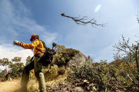 A member of the Roosevelt Hotshot Crew clears a firebreak while battling the Windy Fire on Thursday, Sept. 16, 2021, on the Tule River Reservation, Calif. His crew, which travelled from Colorado, has been battling California wildfires. (AP Photo/Noah Berger)