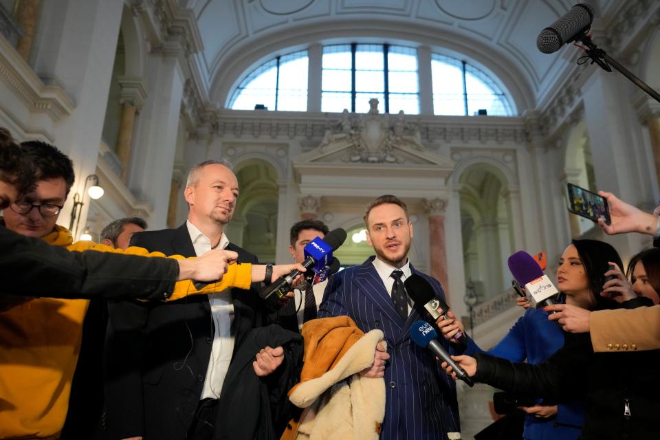 Ioan Gliga left and Eugen Vidineac, Romanian lawyers for Andrew Tate speak at the Court of Appeal in Bucharest (AP)