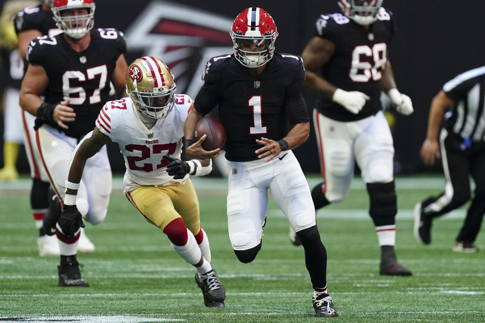 Atlanta Falcons quarterback Marcus Mariota (1) runs against San Francisco 49ers cornerback Dontae Johnson (27) during the first half of an NFL football game, Sunday, Oct. 16, 2022, in Atlanta. (AP Photo/John Bazemore)