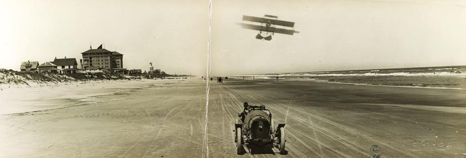 A racer and Wright biplane on the beach at Seabreeze in 1911.