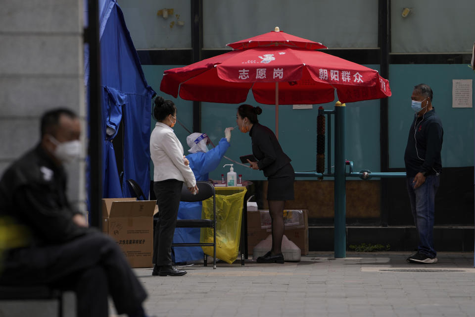 People get swabbed during a public COVID-19 testing at a site after authorities ordered a third round of three consecutive coronavirus tests for residents in the Chaoyang district on Monday, May 9, 2022, in Beijing. (AP Photo/Andy Wong)