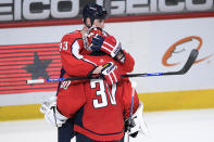 Washington Capitals defenseman Zdeno Chara (33) celebrates with goaltender Ilya Samsonov (30) after the team's 6-1 win over the Philadelphia Flyers in an NHL hockey game Tuesday, April 13, 2021, in Washington. (AP Photo/Nick Wass)