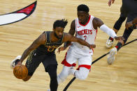 Chicago Bulls guard Coby White, left, drives with the ball against Houston Rockets guard Victor Oladipo, right, during the first half of an NBA basketball game Monday, Jan. 18, 2021, in Chicago. (AP Photo/Matt Marton)