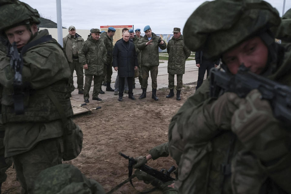 FILE - In this handout photo released by Russian Defense Ministry Press Service, Russian President Vladimir Putin, center, Russian Defense Minister Sergei Shoigu, left, and Deputy Commander of the Airborne Troops Anatoly Kontsevoy, right, visit a military training centre of the Western Military District for mobilised reservists in Ryazan Region, Russia, Oct. 20, 2022. The mobilized reservists that Russian President Vladimir Putin visited last week at a firing range southeast of Moscow looked picture-perfect. (Russian Defense Ministry Press Service via AP, File)