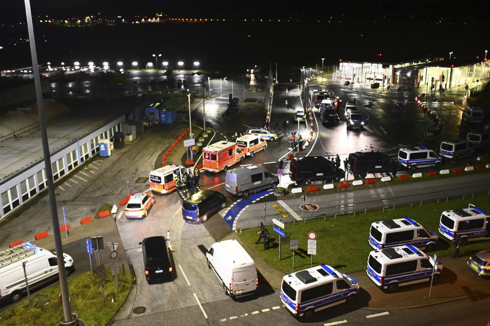 Police vehicles and ambulances arrive at the scene of a security breach at the Hamburg Airport, Saturday, Nov. 4, 2023, in Hamburg, Germany. The airport was closed to passengers, and flights were canceled Saturday night after a vehicle broke through security and entered the premises, German news agency dpa reported. (Jonas Walzberg/dpa via AP)