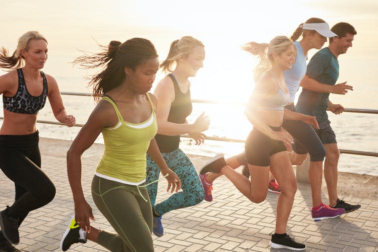 A group of people running together outside.