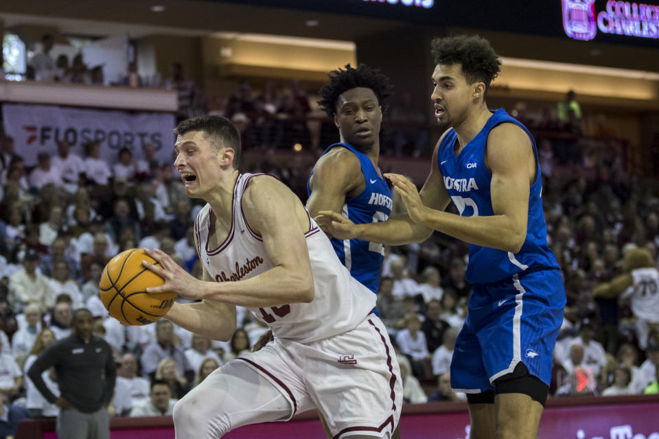 Charleston forward Ante Brzovic, left, drives to the basket between two Hofstra defenders during the first half of an NCAA college basketball game, Saturday, Jan. 28, 2023, in Charleston, S.C. (AP Photo/Stephen B. Morton)