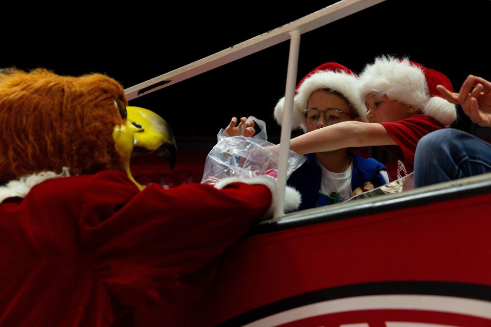 Swoop gives candy canes to fans during the women’s college basketball game between the University of Utah and Weber State University at the Jon M. Huntsman Center in Salt Lake City on Thursday, Dec. 21, 2023. | Megan Nielsen, Deseret News