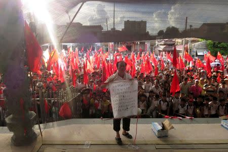 Villager Wei Yonghan makes a speech before assembled Wukan villagers, who are demanding justice for a series of land grabs and for the release of their elected village chief Lin Zuluan, who was arrested by authorities, in the southern province of Guangdong, China June 20, 2016. Picture taken June 20, 2016. REUTERS/James Pomfret