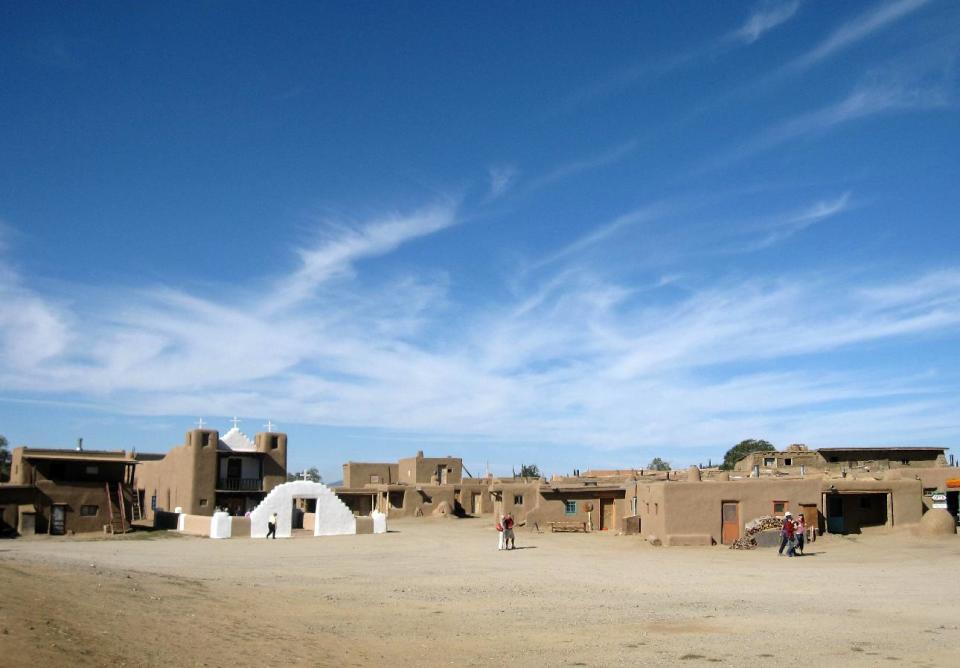 This October 2012 photo shows adobe dwellings at the Taos Pueblo in Taos, N.M., a UNESCO World Heritage site where the Taos native people have lived for 1,000 years. Tours of the pueblo describe the community’s survival and challenges across the centuries. The picture-perfect dwellings are multi-level, often with ladders to reach upper floors and round ovens outside. (AP Photo/Beth Harpaz)