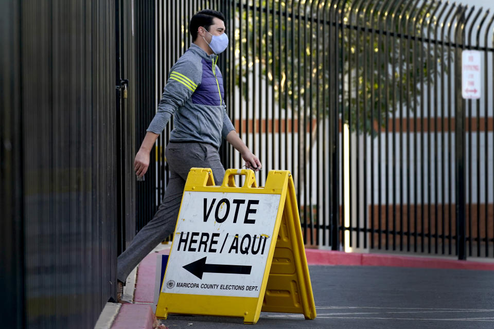 A voter leaves after casting his ballot at a polling station, Tuesday, Nov. 3, 2020, in Phoenix. (AP Photo/Matt York)