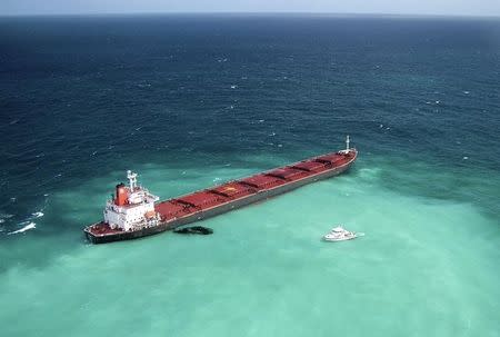 Oil is seen next to the 230-metre (754-ft) bulk coal carrier Shen Neng I about 70 km (43 miles) east of Great Keppel Island in this April 4, 2010 picture. REUTERS/Maritime Safety Queensland/Handout