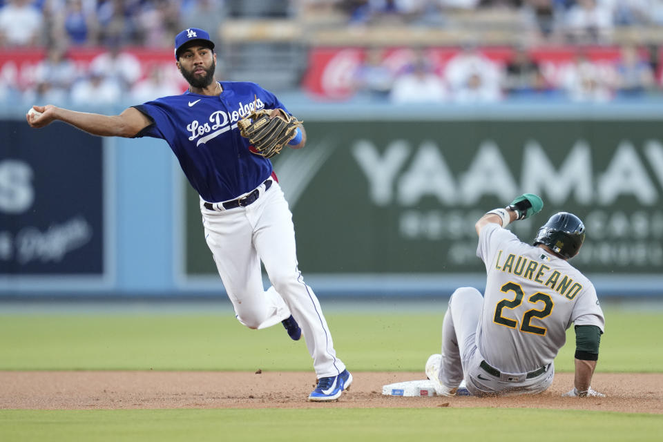 Los Angeles Dodgers second baseman Amed Rosario (31) throws to first base for a double play during the first inning of a baseball game against the Oakland Athletics in Los Angeles, Thursday, Aug. 3, 2023. Oakland Athletics' Ramon Laureano (22) was out at second and Brent Rooker was out at first. (AP Photo/Ashley Landis)