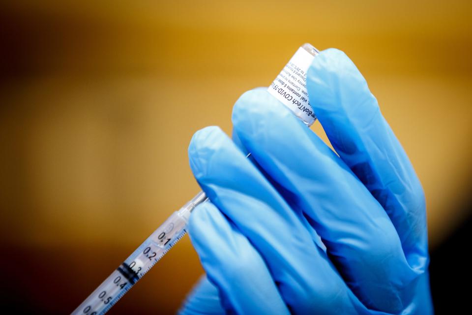 Doses of the Pfizer COVID-19 vaccine are drawn into syringes at a clinic in 2021. Officials in Polk County have seen a rise in concentrations of the virus traced in wastewater across the county.