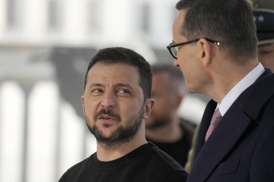 Poland's Prime Minister Mateusz Morawiecki, right, and Ukrainian President Volodymyr Zelenskyy attend a ceremony at the Tomb of the Unknown Soldier during his visit to Warsaw, Poland, Wednesday, April 5, 2023. (AP Photo/Czarek Sokolowski)