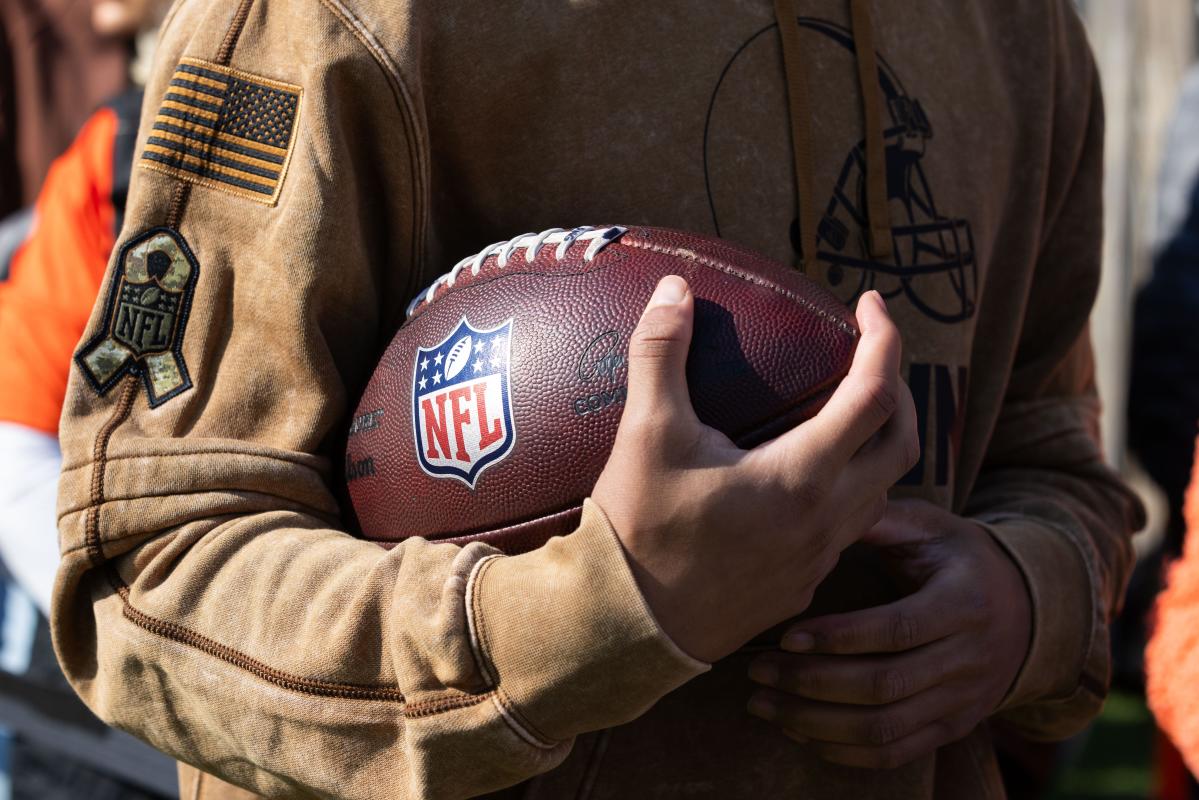 What is the reason that some American football balls are brown/tan