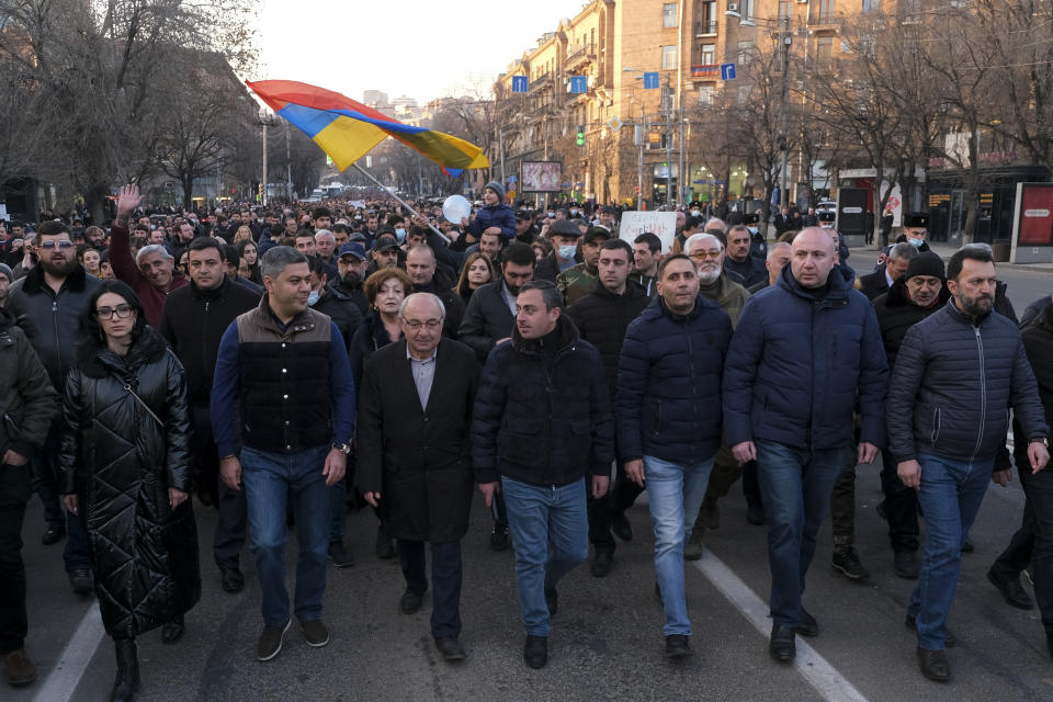 Opposition demonstrators march to the government buildings during a rally to pressure Armenian Prime Minister Nikol Pashinyan to resign in Yerevan, Armenia, Saturday, Feb. 27, 2021. The developments come after months of protests sparked by the nation's defeat in the Nagorno-Karabakh conflict with Azerbaijan. (Hrant Khachatryan/PAN Photo via AP)