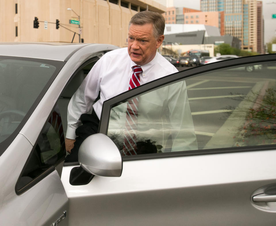Former Fiesta Bowl executive director John Junker gets into his car outside the Sandra Day O'Connor U.S. courthouse after being sentenced in Phoenix on Thursday, March 13, 2014. Junker was sentenced to eight months in federal prison for participating in a scheme in which bowl employees made illegal campaign contributions to politicians and were reimbursed by the nonprofit bowl. (AP Photo/The Arizona Republic, Michael Schennum) MARICOPA COUNTY OUT; MAGS OUT; NO SALES