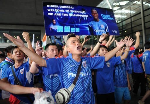 Shanghai Shenhua fans welcome Didier Drogba as he arrives at Pudong international airport in Shanghai on July 14. Drogba is the latest in a fast-growing number of foreign stars to have been lured to China on enormous salaries that are typically funded by Chinese business titans