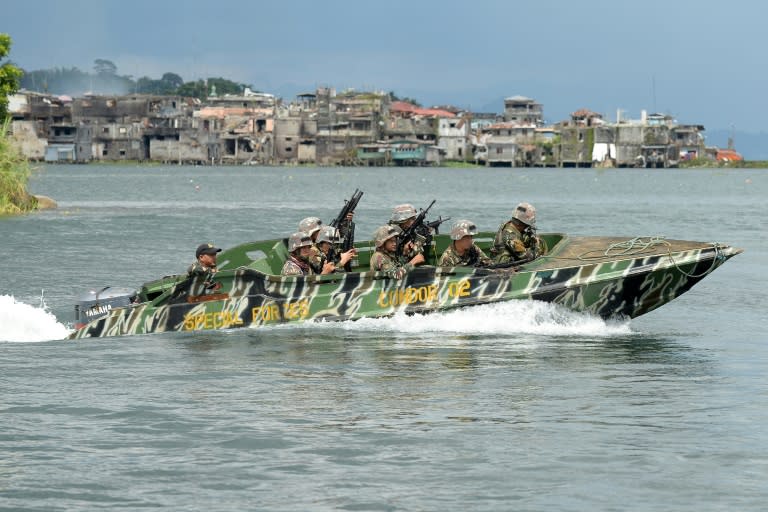 Philippine soldiers patrol a lake near the frontline in Marawi, on the southern island of Mindanao, on June 19, 2017