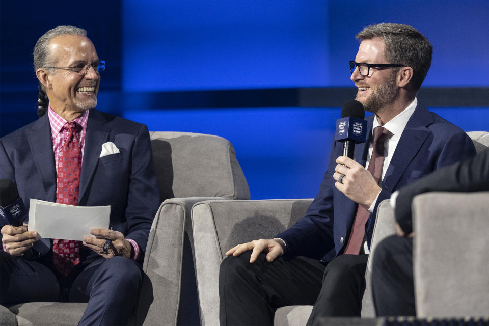 NASCAR Hall of Fame inductee Dale Earnhardt Jr., right, and Kyle Petty smile prior to the induction ceremony Friday, Jan. 21, 2022, in Charlotte, N.C. (AP Photo/Matt Kelley)