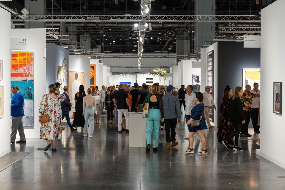 Visitors explore Art Basel Miami Beach last year. This year's event will be from Dec. 8-10 at the Miami Beach Convention Center, with 277 galleries participating.