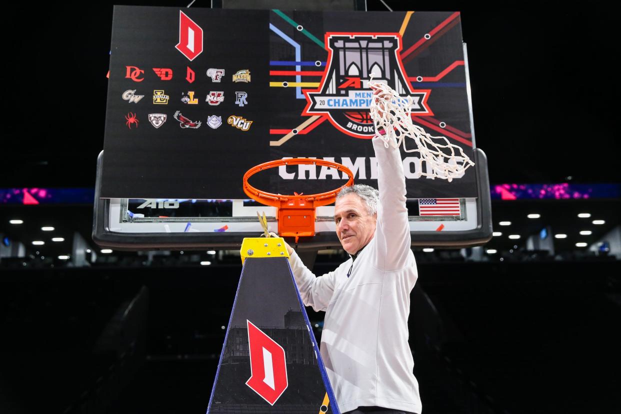 Mar 17, 2024; Brooklyn, NY, USA; Duquesne Dukes head coach Keith Dambrot cuts the nets after winning the Atlantic 10 Tournament Championship at Barclays Center. Mandatory Credit: Wendell Cruz-USA TODAY Sports