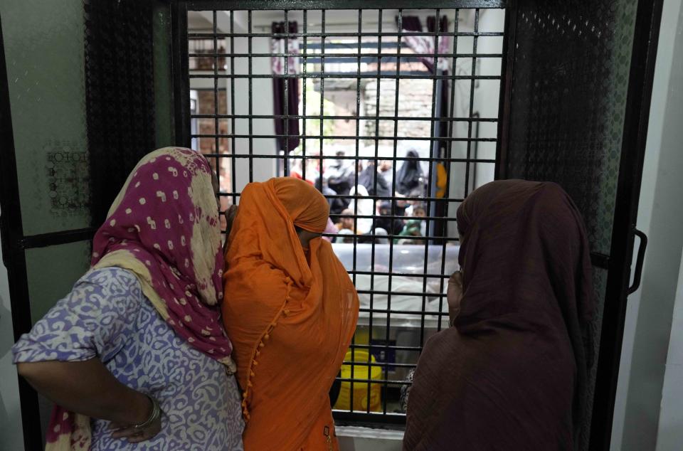 Women mourn as they look at the body of their young neighbour Mohamed Usman, 15, who was killed by lightning on Friday at Prayagraj, in the northern Indian state of Uttar Pradesh, India. Saturday, Sept. 24, 2022. Hazardous weather killed at least 36 people in northern India over the past 24 hours, including 12 who died after being struck by lightning, officials said as they warned of more heavy downpours in the coming days. Usman was walking on a roof when he was struck by lightning. (AP Photo/Rajesh Kumar Singh)