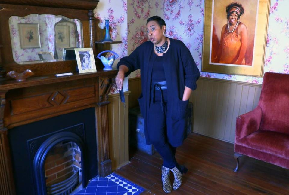 Florene Dawkins is the director of the Gertrude “Ma” Rainey House and Blues Museum in Columbus, Georgia. The painting to the right of Dawkins is a portrait of Rainey.