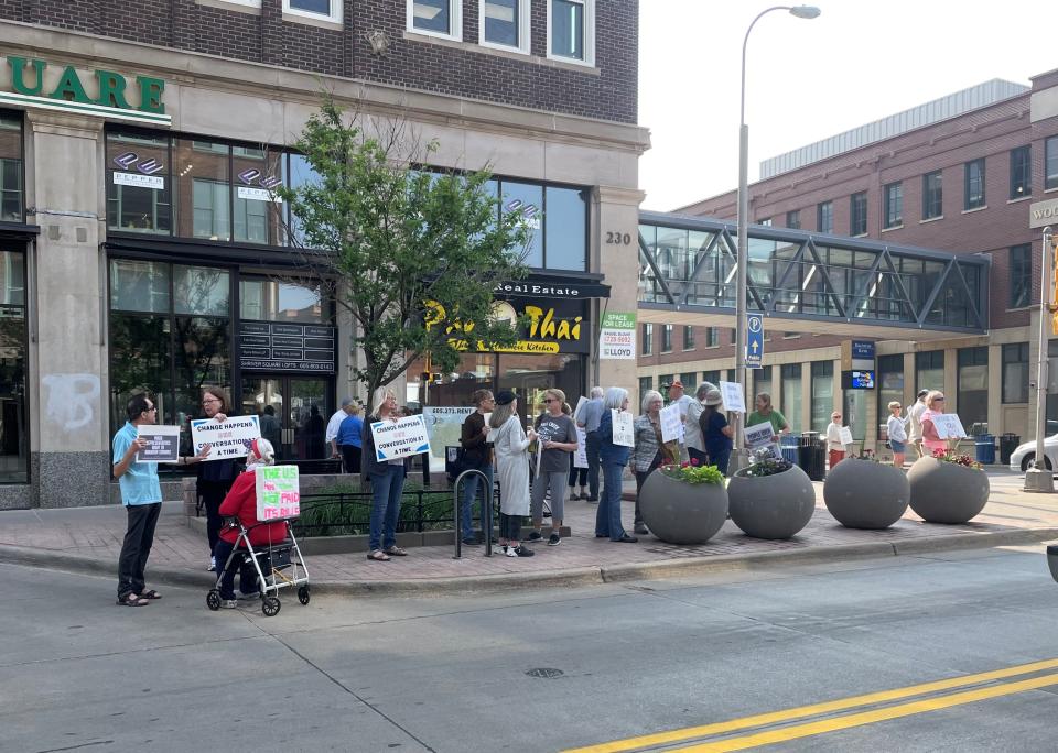 Members of Common Grounds Indivisible SD stand in front of Rep. Dusty Johnson's downtown Sioux Falls office to protest the impending debt limit on Tuesday May 23, 2023.