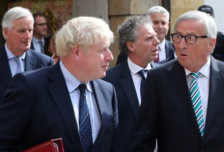 British Prime Minister Boris Johnson, European Commission President Jean-Claude Juncker and European Union's chief Brexit negotiator Michel Barnier leave after their meeting in Luxembourg
