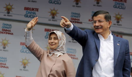 Turkey's Prime Minister Ahmet Davutoglu and his wife Sare gesture to their supporters during an election rally for Turkey's June 7 parliamentary elections in Ankara, Turkey, May 30, 2015. REUTERS/Umit Bektas