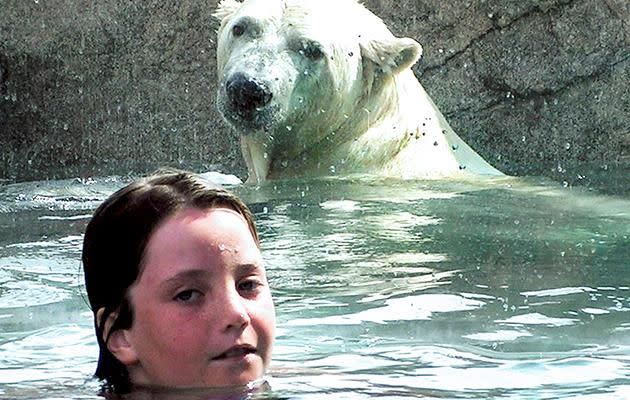 Is this little girl in danger while swimming with the polar bear? Photo: Caters News