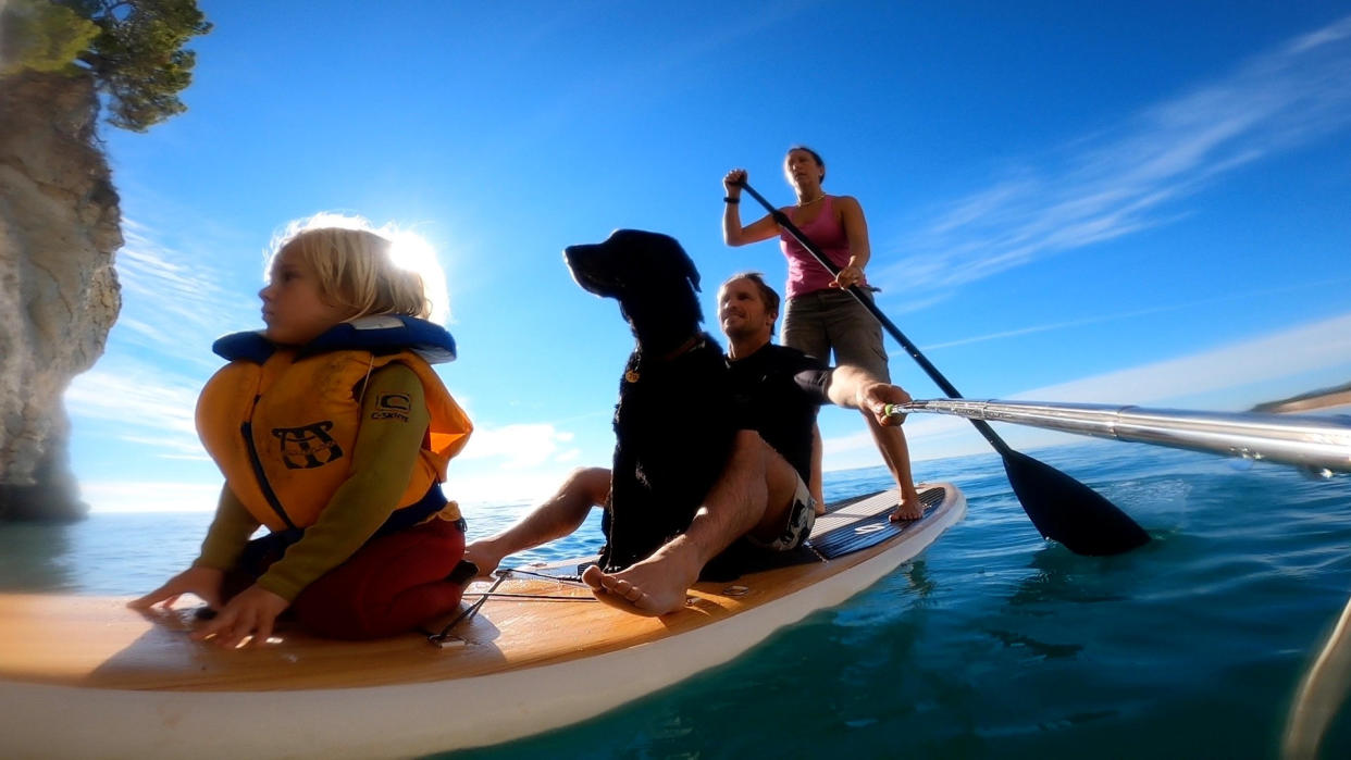 Ross and Sarah Barrett travel the world with their son Riley, five, and their black labrador Maui. (SWNS)