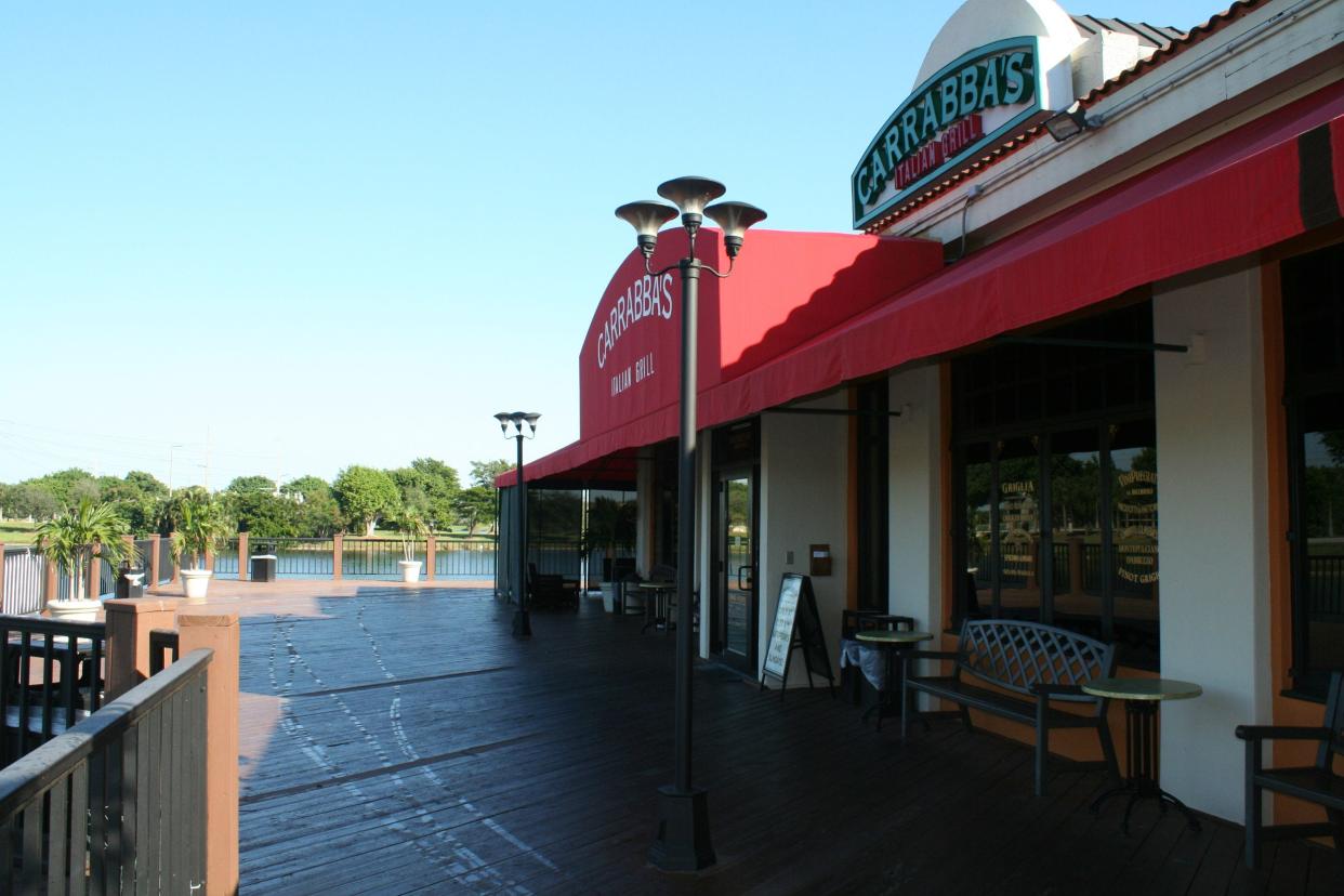 Located in the Wharfside at Boca Pointe shopping center, Carrabbas Italian Grill has an outside patio on the wooden deck overlooking a small lake.