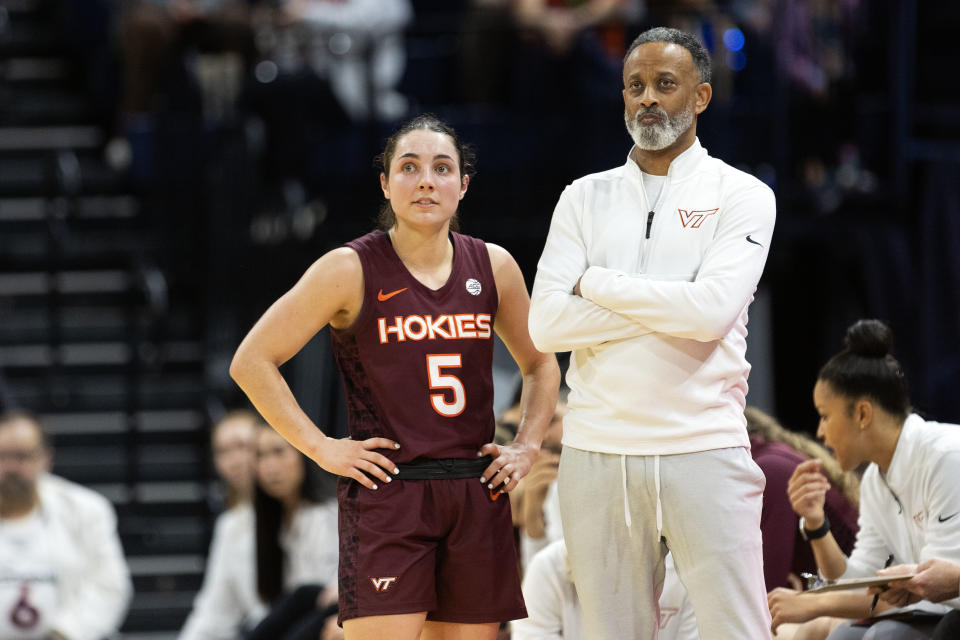 CHARLOTTESVILLE, VIRGINIA - MARCH 3: Georgia Amoore #5 and head coach Kenny Brooks of the Virginia Tech Hokies watch a free throw in the first half against the Virginia Cavaliers at John Paul Jones Arena on March 3, 2024 in Charlottesville, Virginia. (Photo by Ryan M. Kelly/Getty Images)