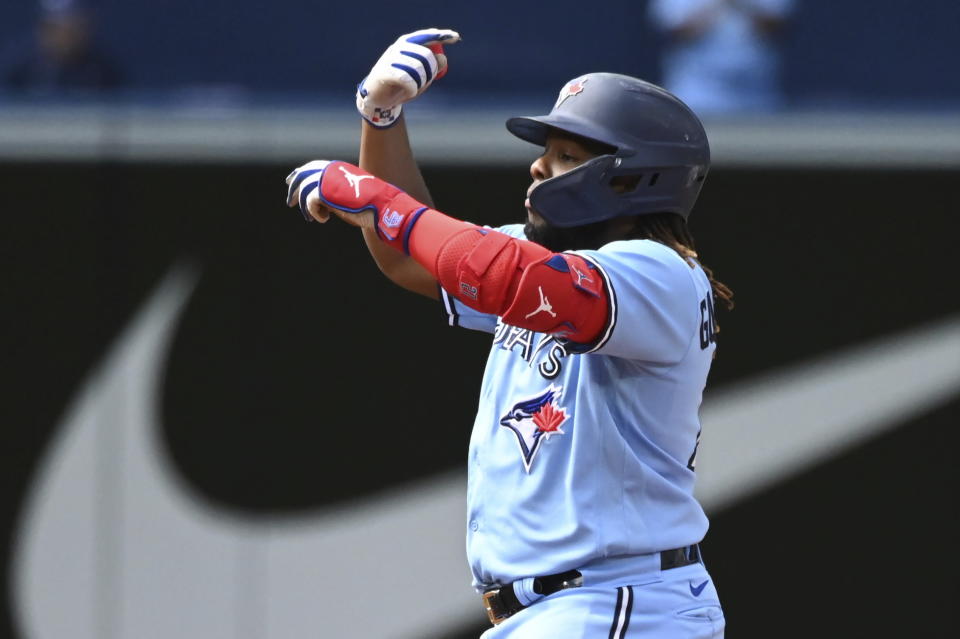 Toronto Blue Jays' Vladimir Guerrero Jr. motions to the dugout after hitting a ground rule double off Cleveland Guardians starting pitcher Triston McKenzie in first-inning baseball game action in Toronto, Saturday, Aug. 13, 2022. (Jon Blacker/The Canadian Press via AP)