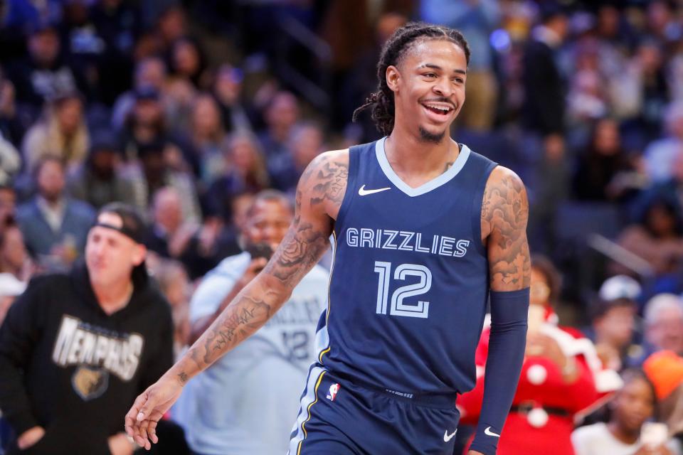 Grizzlies' Ja Morant (12) reacts after making a three pointer as Grizzlies fans cheer for him during the game between the Indiana Pacers and Memphis Grizzlies at FedExForum in Memphis, Tenn., on Thursday, December 21, 2023.