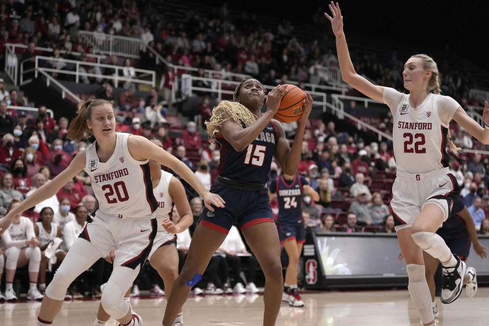 Gonzaga forward Yvonne Ejim (15) drives to the basket against Stanford's Elena Bosgana (20) and Cameron Brink (22) during the first half of an NCAA college basketball game in Stanford, Calif., Sunday, Dec. 4, 2022. (AP Photo/Tony Avelar)