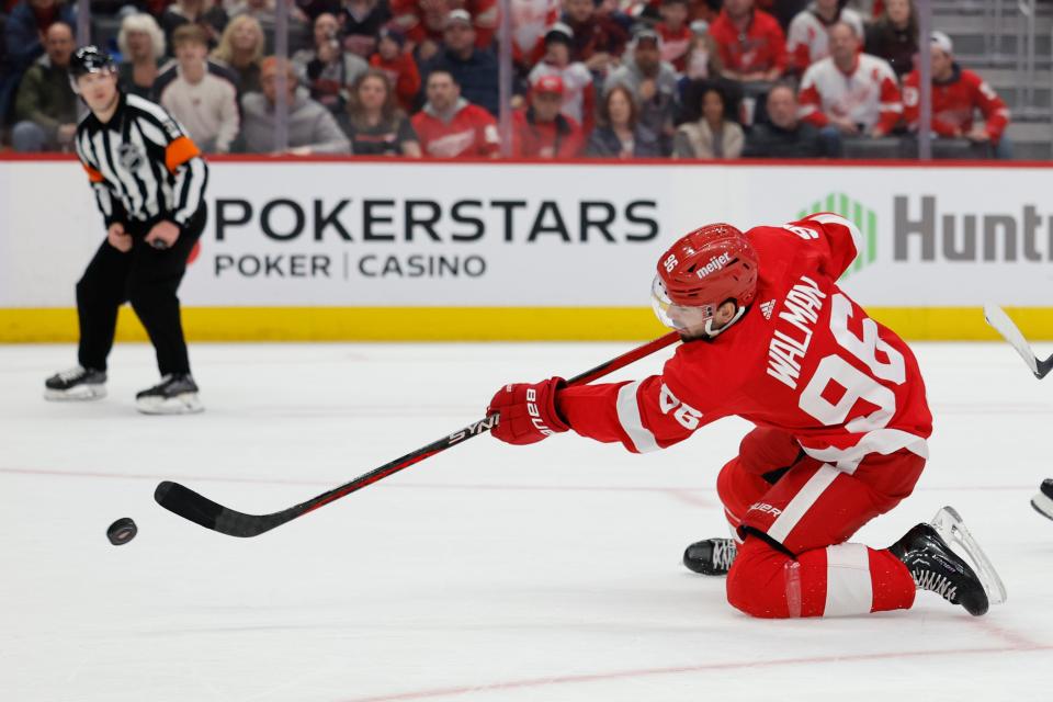 Detroit Red Wings defenseman Jake Walman (96) takes a shot in overtime against the Vancouver Canucks at Little Caesars Arena in Detroit on Saturday, Feb. 10, 2024.