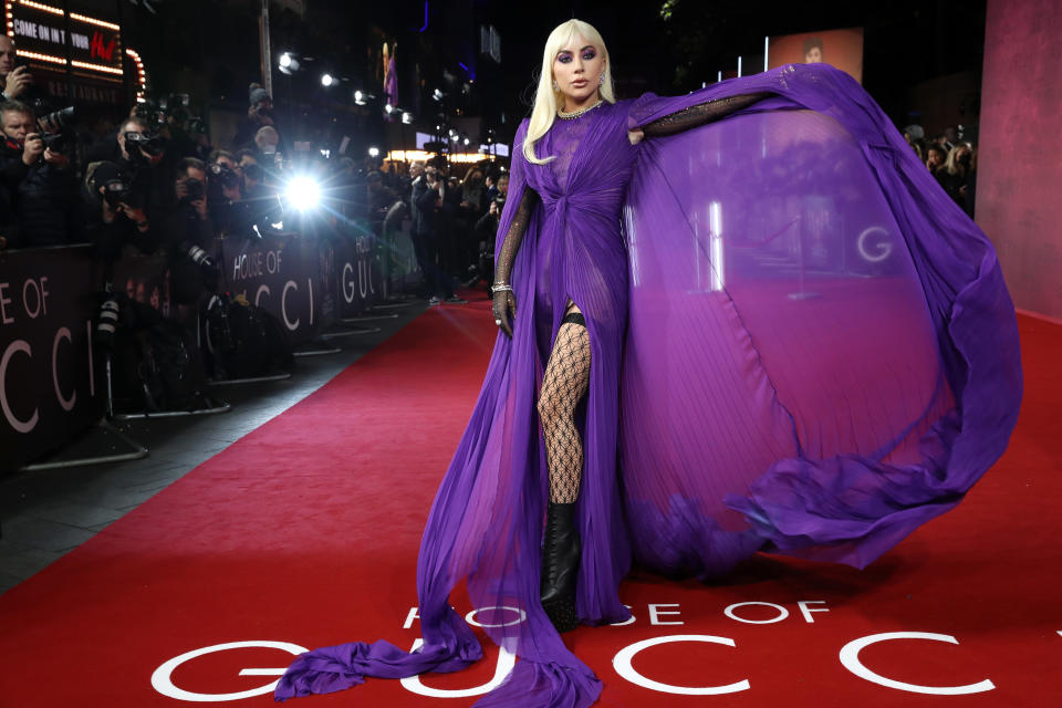 Gaga holding up one side of her gown like it's a cape