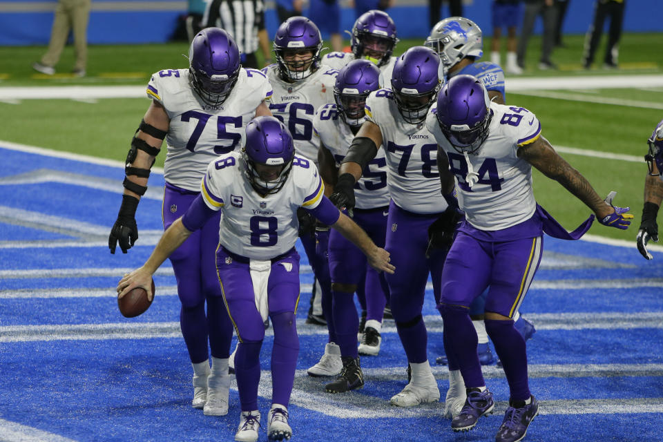 Minnesota Vikings quarterback Kirk Cousins (8) and teammates react after Cousins' touchdown during the second half of an NFL football game against the Detroit Lions, Sunday, Jan. 3, 2021, in Detroit. (AP Photo/Duane Burleson)