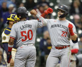 Minnesota Twins' Ryan Jeffers (27) reacts with Will Castro (50) after he hit a three-run home run during the seventh inning of a baseball game against the Milwaukee Brewers Wednesday, April 3, 2024, in Milwaukee. (AP Photo/Jeffrey Phelps)