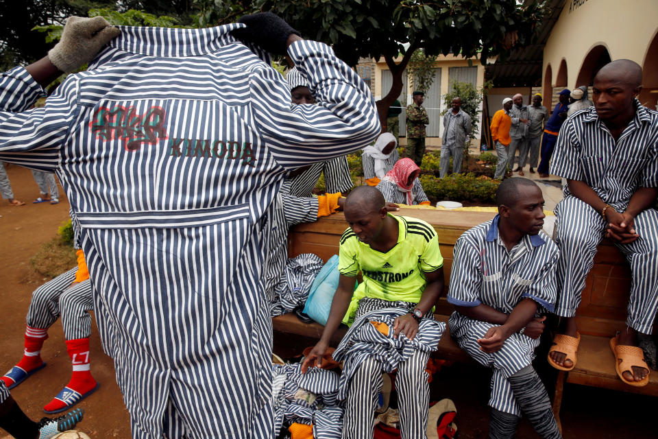 <p>A Kenyan prisoner changes back to his prison uniform after participating in a mock World Cup soccer match between Russia and Saudi Arabia as part of a soccer tournament involving eight prison teams at the Kamiti Maximum Security Prison, near Nairobi, Kenya, June 14, 2018. (Photo: Baz Ratner/Reuters) </p>