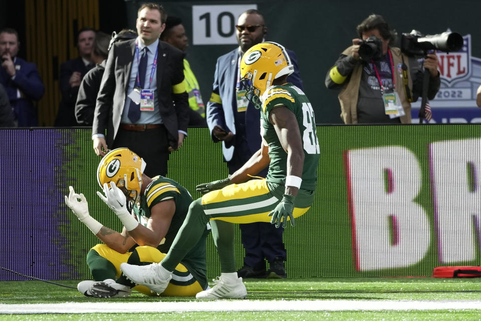 Green Bay Packers wide receiver Allen Lazard (13), left, celebrates after scoring a touchdown during an NFL game between the New York Giants and the Green Bay Packers at the Tottenham Hotspur stadium in London, Sunday, Oct. 9, 2022. (AP Photo/Kin Cheung)