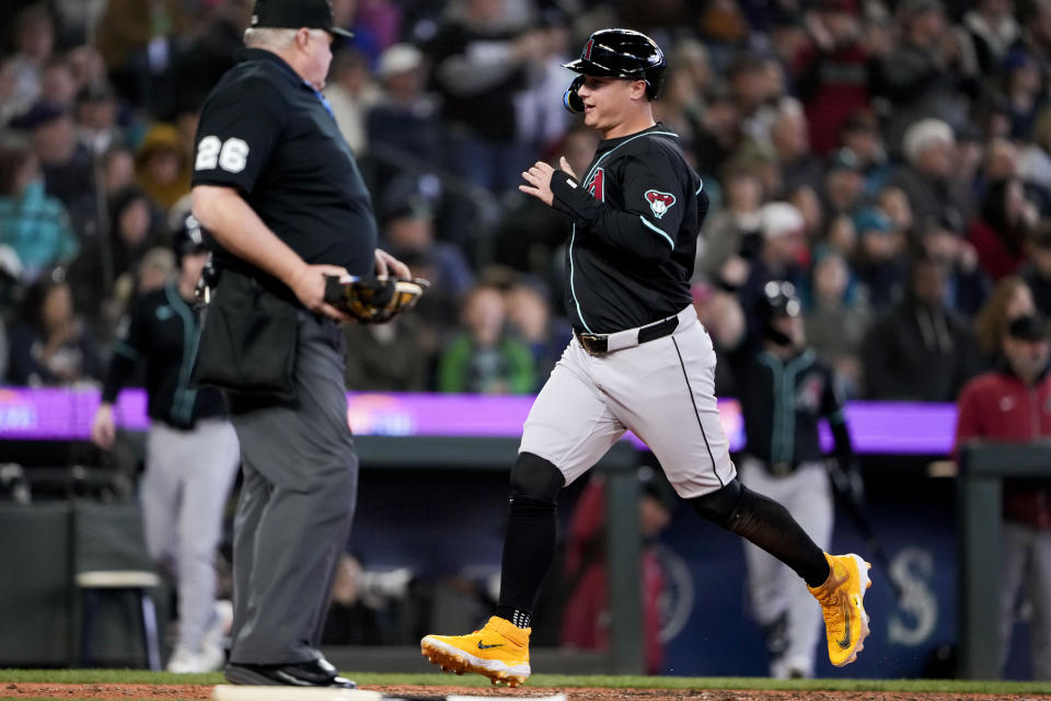 Arizona Diamondbacks' Joc Pederson scores on an RBI double from Eugenio Suárez against the Seattle Mariners during the seventh inning of a baseball game Sunday, April 28, 2024, in Seattle. (AP Photo/Lindsey Wasson)